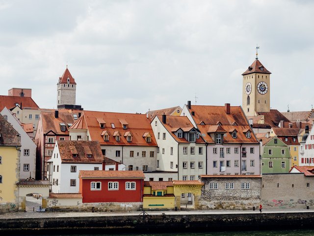 Romantik Hotel Hirschen: Bildergalerie Historische Häuser und Uhrturm an einem Flussufer unter bewölktem Himmel