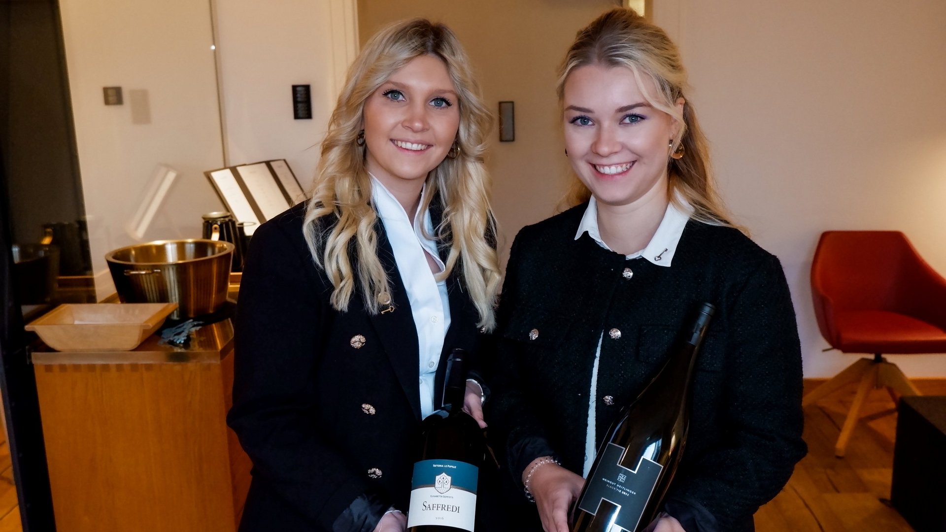 Romantik Hotel Hirschen: cuisine Two women holding wine bottles indoors