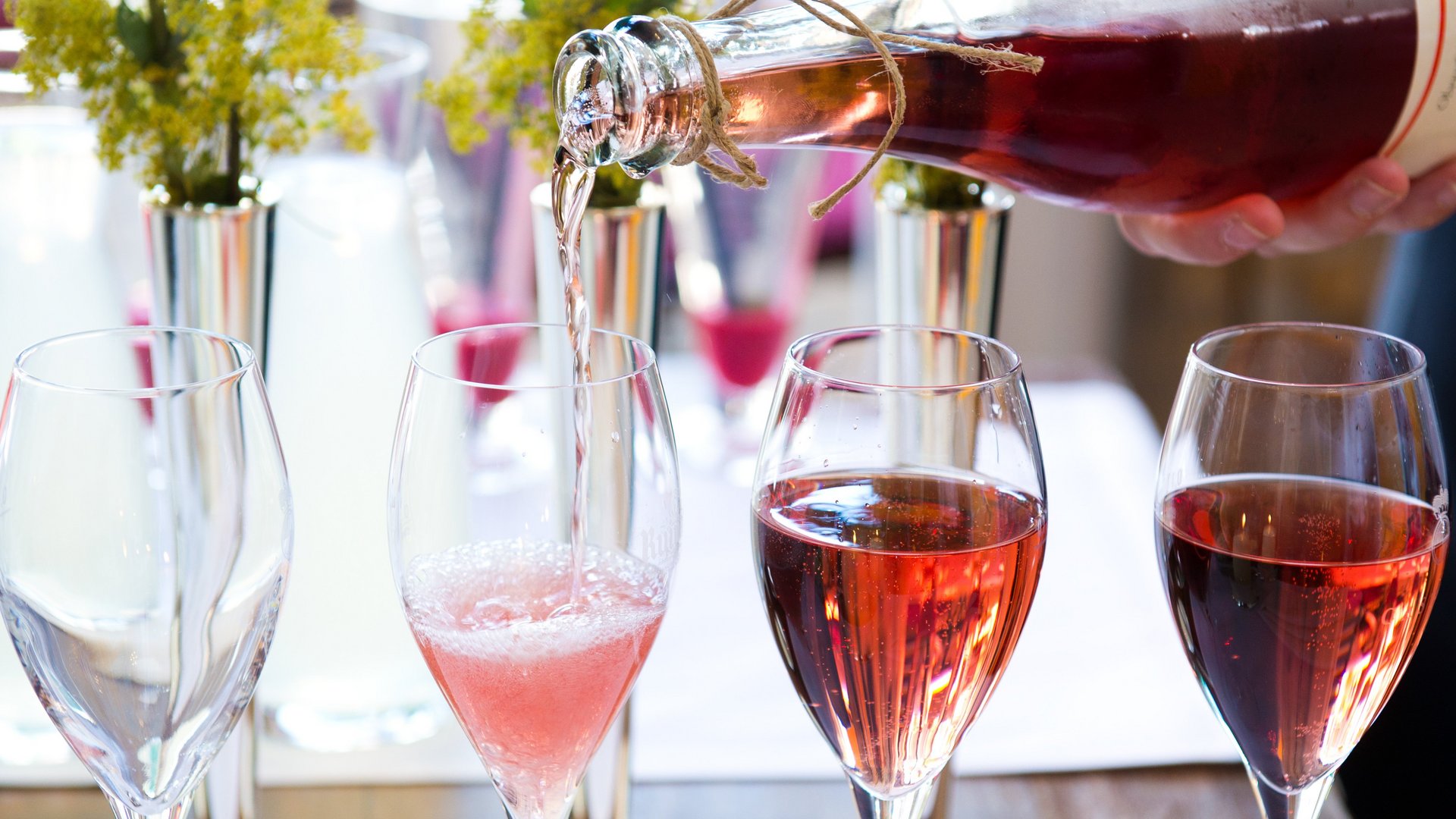 Romantik Hotel Hirschen: cuisine Rosé wine being poured into champagne glasses on a set dining table
