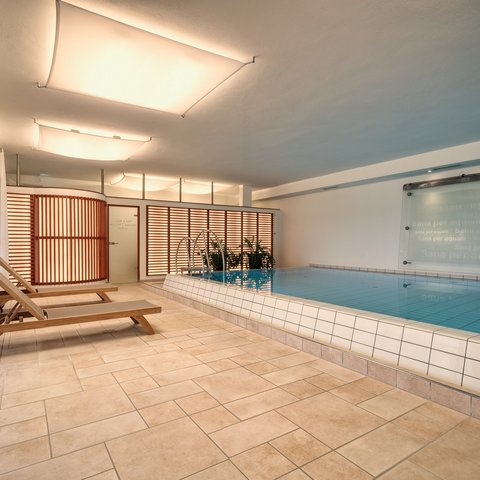 Day wellness in Upper Palatinate Indoor pool area with lounge chairs and modern lighting