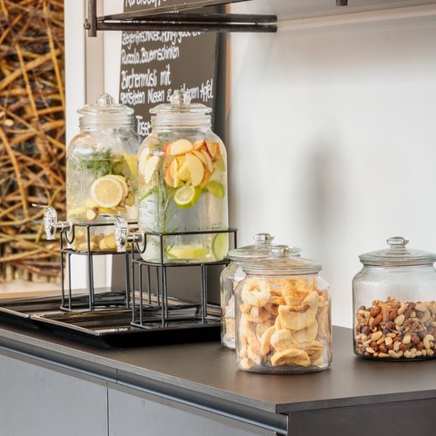 Day wellness in Upper Palatinate Jars of fruit-infused water and snacks on a black buffet