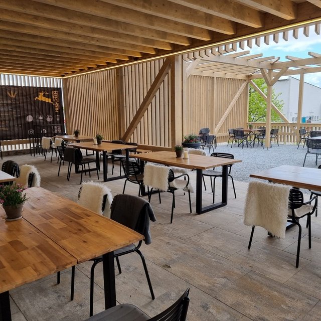 Romantik Hotel Hirschen: cuisine Covered patio with wooden tables and chairs, some with fur covers