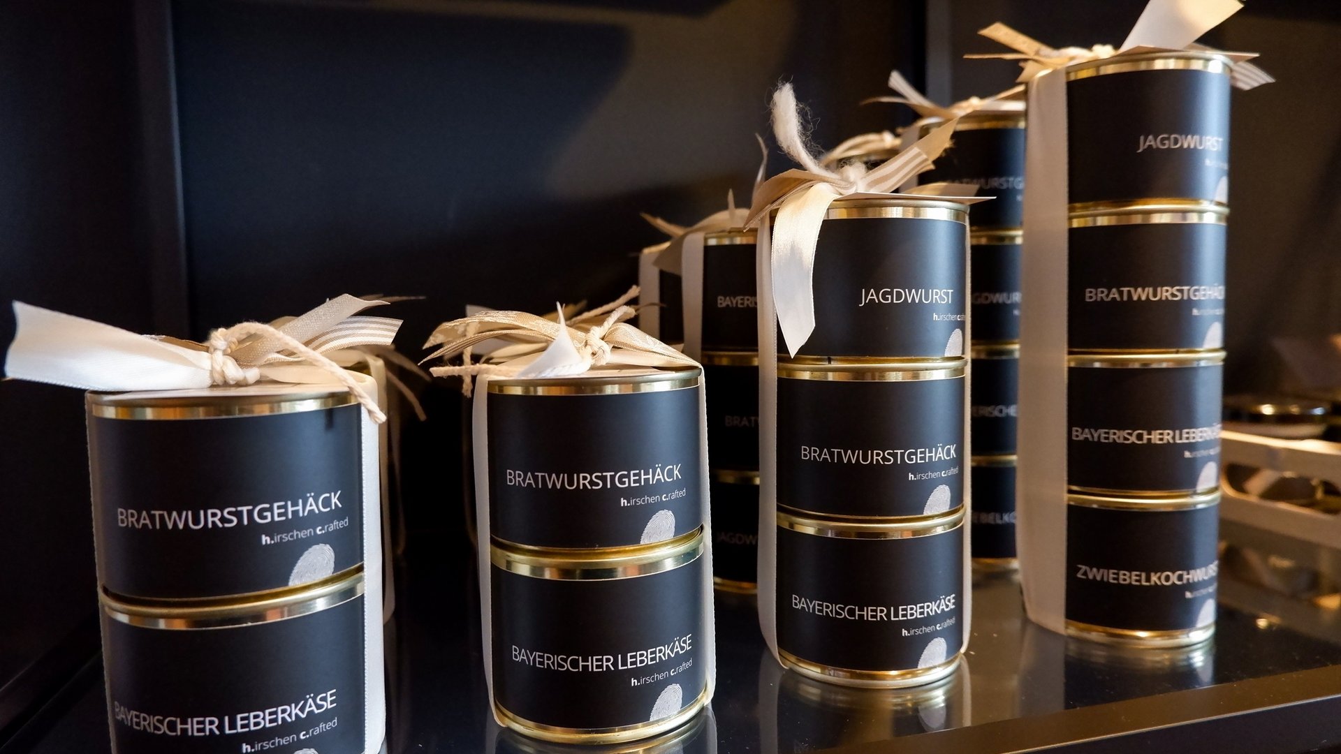 Eco-friendly hotel in Germany with Hirschenmanufaktur Stacked cans of Bavarian sausage and Leberkäse varieties on a shelf