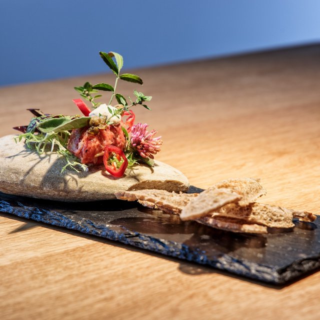 Hotel in Upper Palatinate: Get a breath of holiday air! Creative appetizer with herbs on stone plate and wooden table