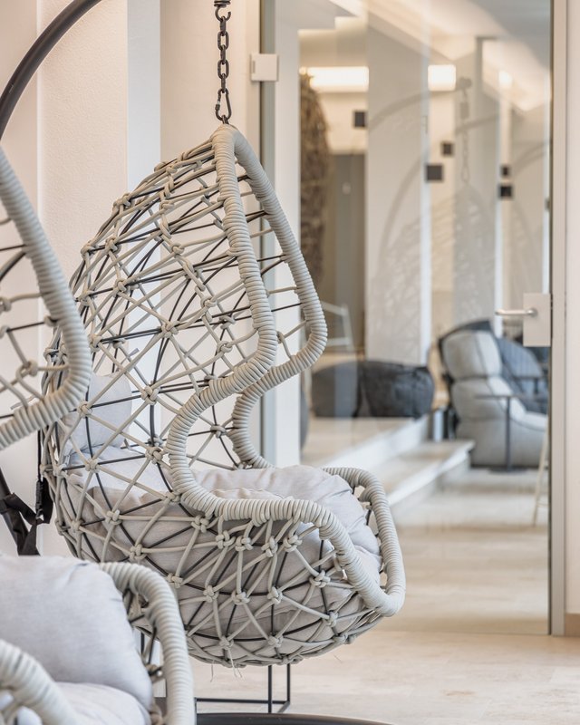 Looking for holiday accommodation in Upper Palatinate? Modern hanging chair with cushions in a bright indoor space