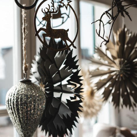 Eco-friendly hotel in Germany with Hirschenmanufaktur Christmas decorations with reindeer and stars hanging by window