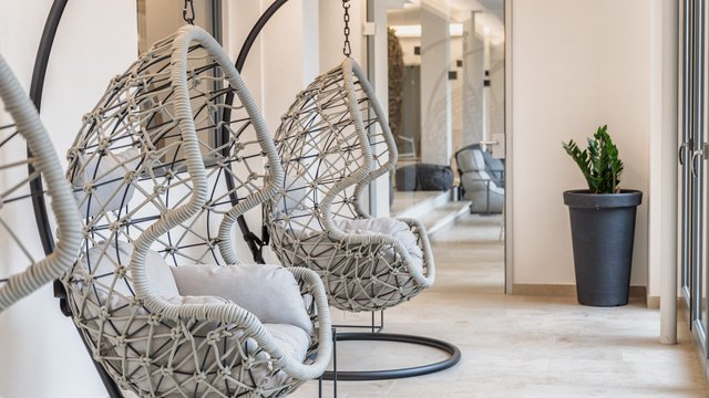 Home Modern hanging chairs with cushions in a bright minimalist room
