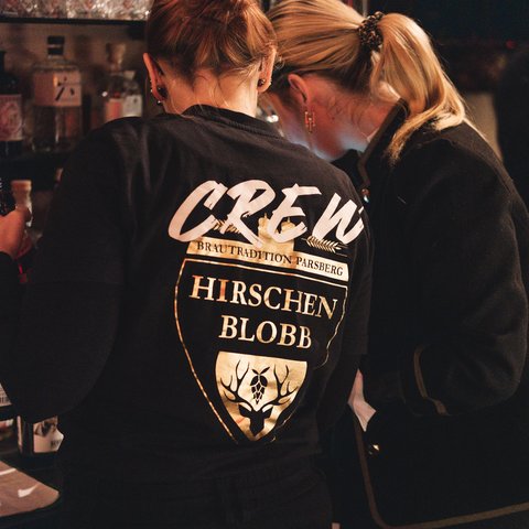 Hirschenblobb: Our bar Two women in a bar, one wearing a crew shirt with deer logo