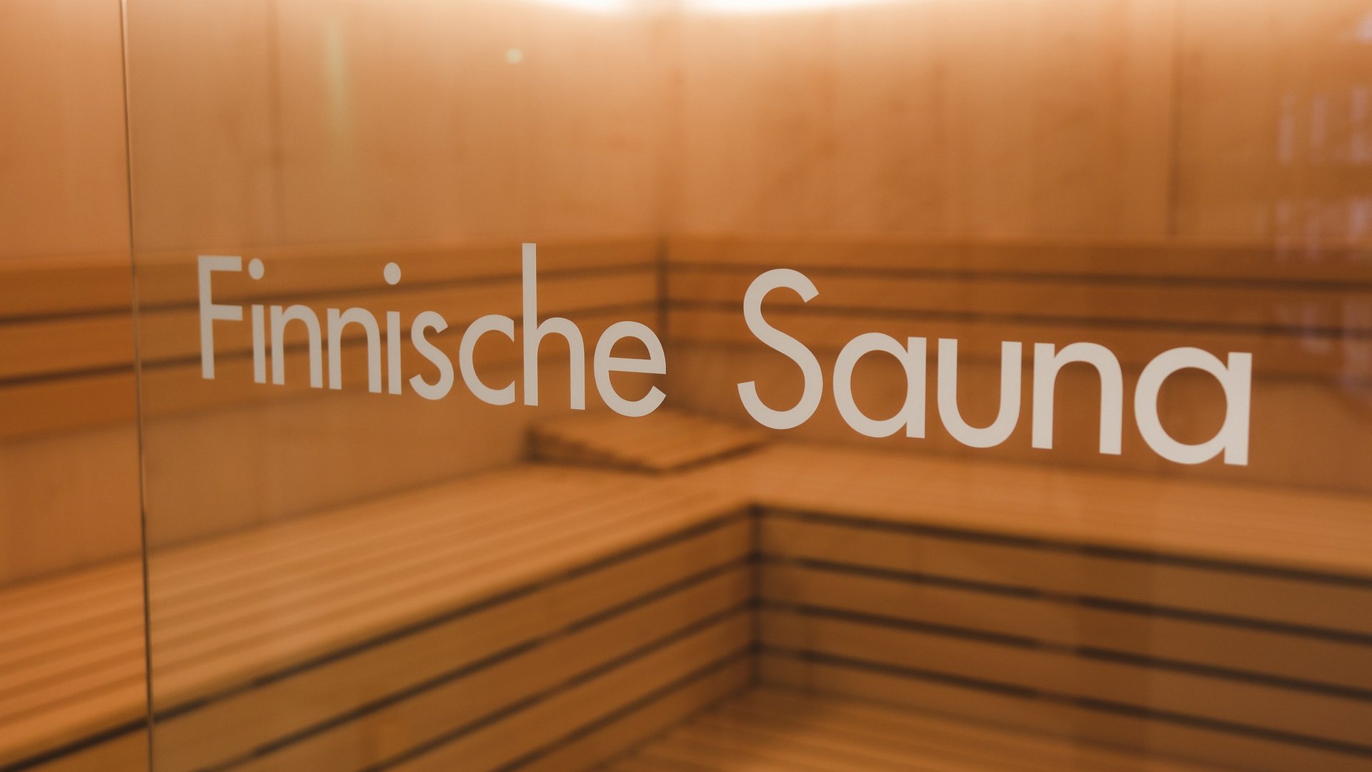 Day wellness in Upper Palatinate Interior of a Finnish sauna with wooden benches and ceiling lighting