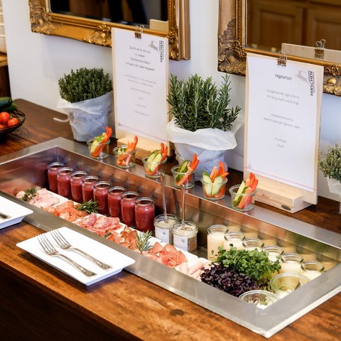 Romantik Hotel Hirschen: Frühstück Buffet mit Wurst, Aufstrichen, Gemüsesticks und Kräutern auf Holztisch