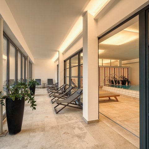 Day wellness in Upper Palatinate Interior view of a wellness area with lounge chairs and swimming pool