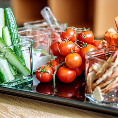 Looking for somewhere for conferences in Bavaria? Fresh vegetables including cucumber, cherry tomatoes, carrot and celery sticks in glass jars