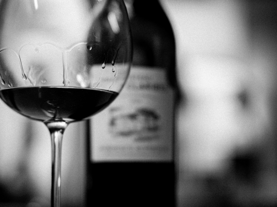 Event calendar 2026 Glass of red wine with blurry wine bottle in black and white
