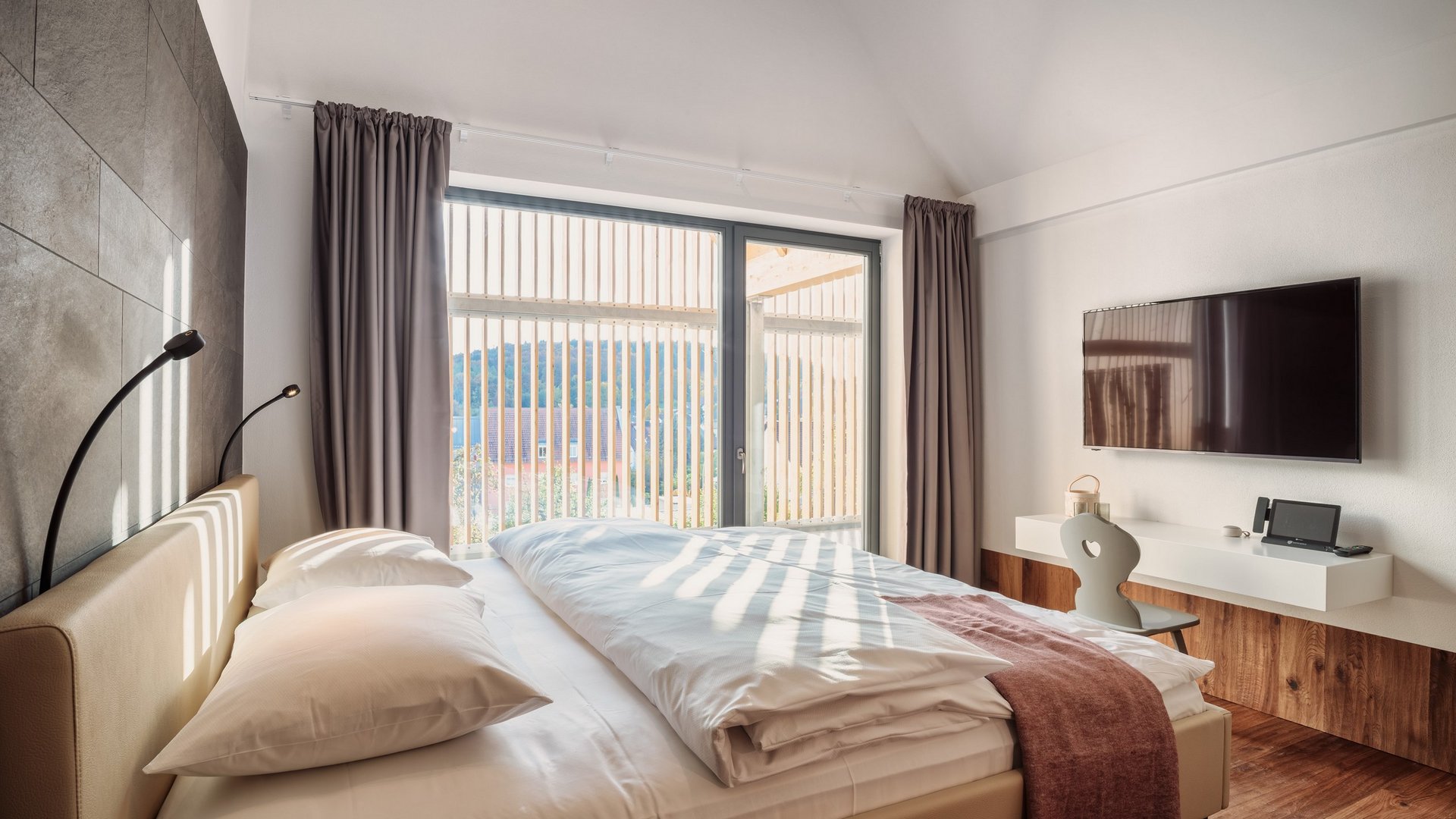 Revel in anticipation Modern bedroom with large window, double bed, and wall-mounted TV