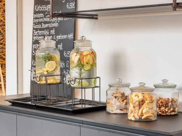 Romantik Hotel Hirschen: picture gallery Water dispensers with fruit next to jars of snacks on a counter