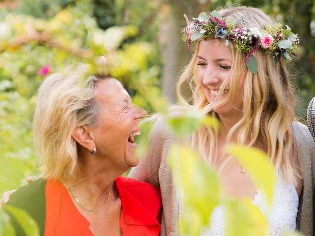 Romantik Hotel Hirschen: picture gallery Happy older woman and young woman with flower crown laughing together in garden