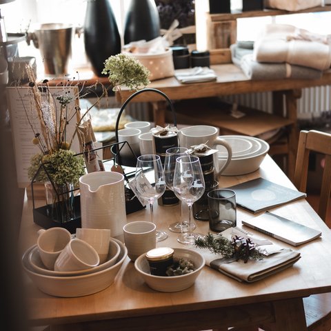 Eco-friendly hotel in Germany with Hirschenmanufaktur Table with ceramics, wine glasses, and decorations in a cozy setting