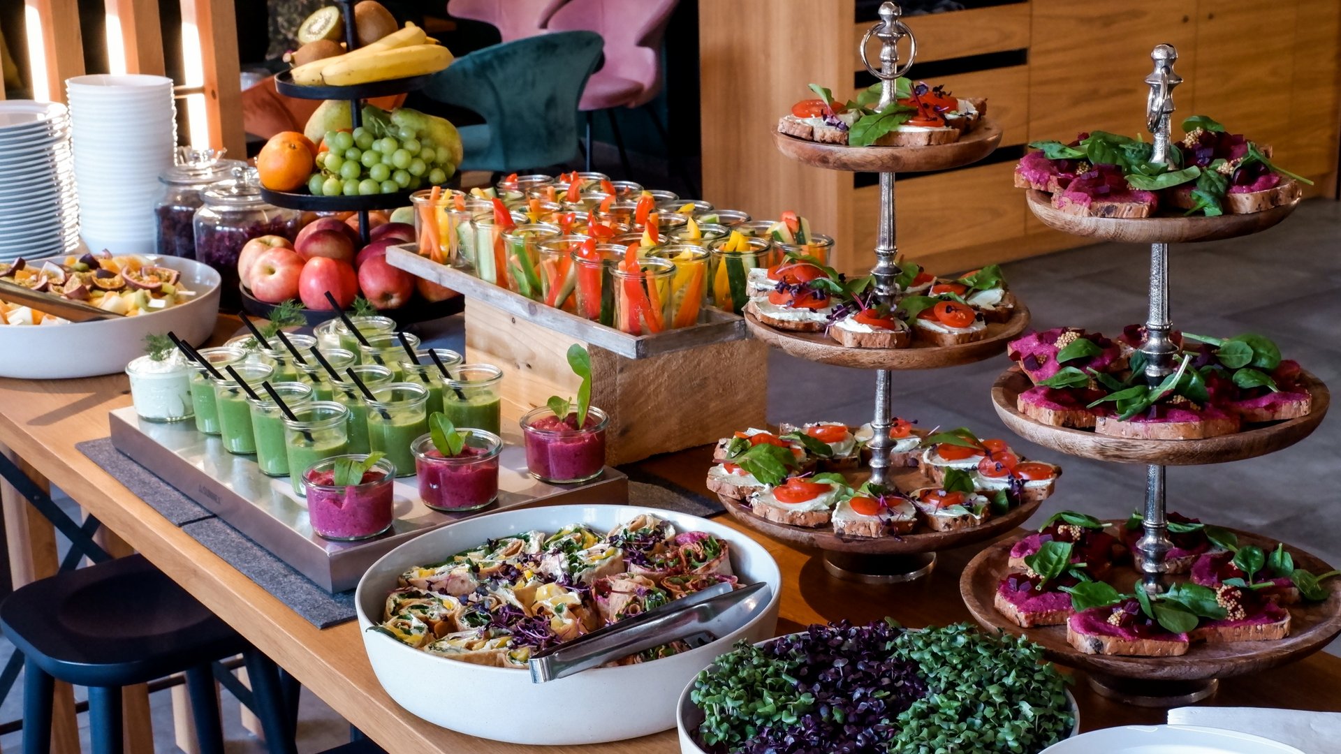 Services and rates for conferences and celebrations Buffet with fresh fruit, vegetable sticks, dips, and topped bread on wooden trays