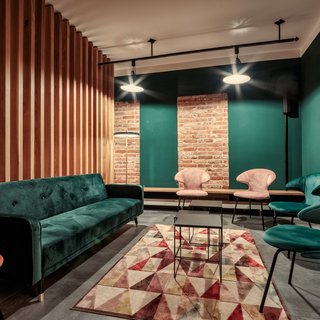 Just a little time(out) Modern waiting area with green sofa and pink chairs