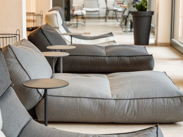 Romantik Hotel Hirschen: picture gallery Large modern gray floor cushions with small side tables in a bright room