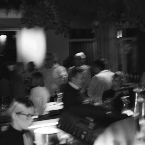 Hirschenblobb: Our bar Blurred people at a dimly lit indoor party