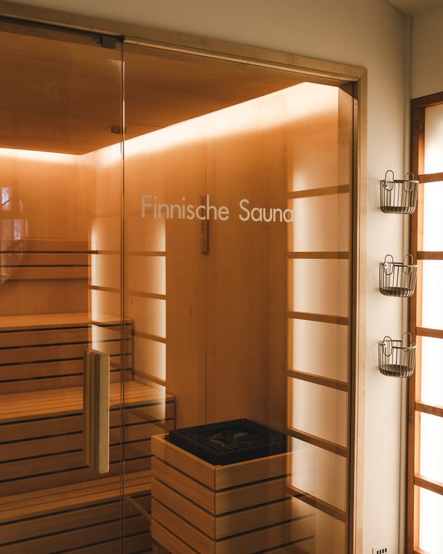 Day wellness in Upper Palatinate Interior of a Finnish sauna with wooden benches and illuminated glass door