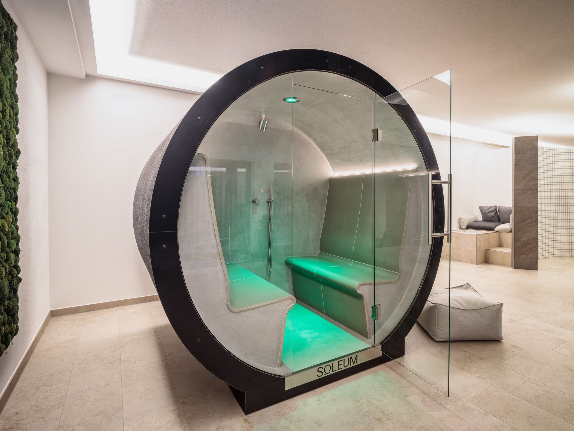 Saunas, Pool & Natural Pool in the Upper Palatinate | Romantik Hotel Hirschen Modern sauna cabin with green LED lighting and glass front