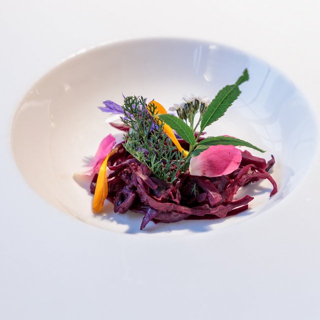 Inclusive services: Everything a stag could want. Artfully plated salad with red cabbage strips and edible flowers