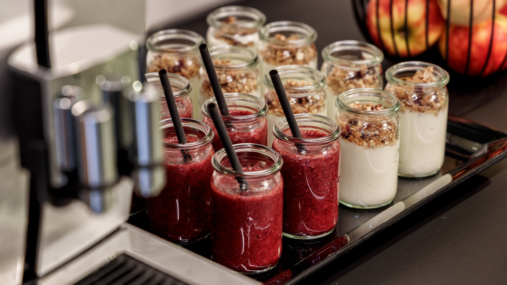 Services and rates for conferences and celebrations Jars of red smoothie and yogurt with granola on a tray