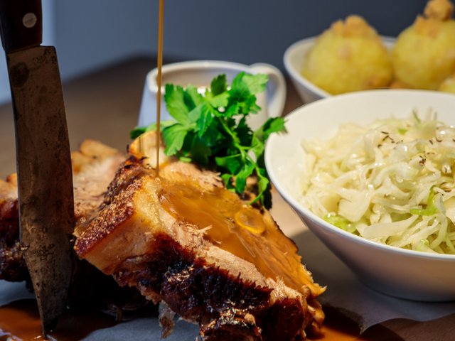 Romantik Hotel Hirschen: picture gallery Sauerbraten with gravy, salad, and dumplings on a plate