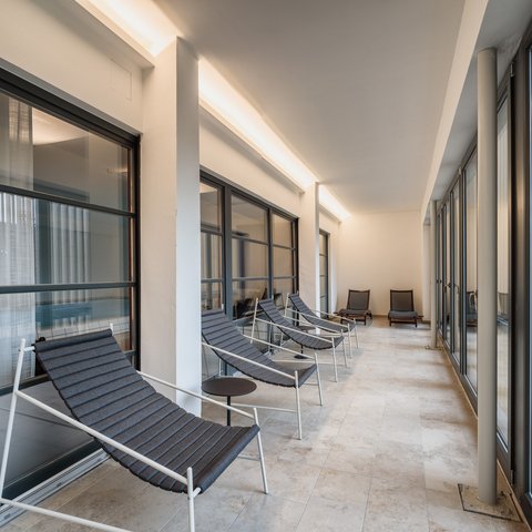 Day wellness in Upper Palatinate Bright relaxation area with multiple gray lounge chairs and large windows