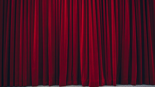 Geschichten aus dem Hirschen und der Oberpfalz. Geschlossene rote Theatervorhänge auf einem grauen Boden