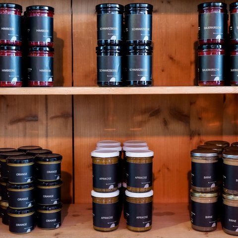 Eco-friendly hotel in Germany with Hirschenmanufaktur Various jars of jam neatly arranged on a wooden shelf