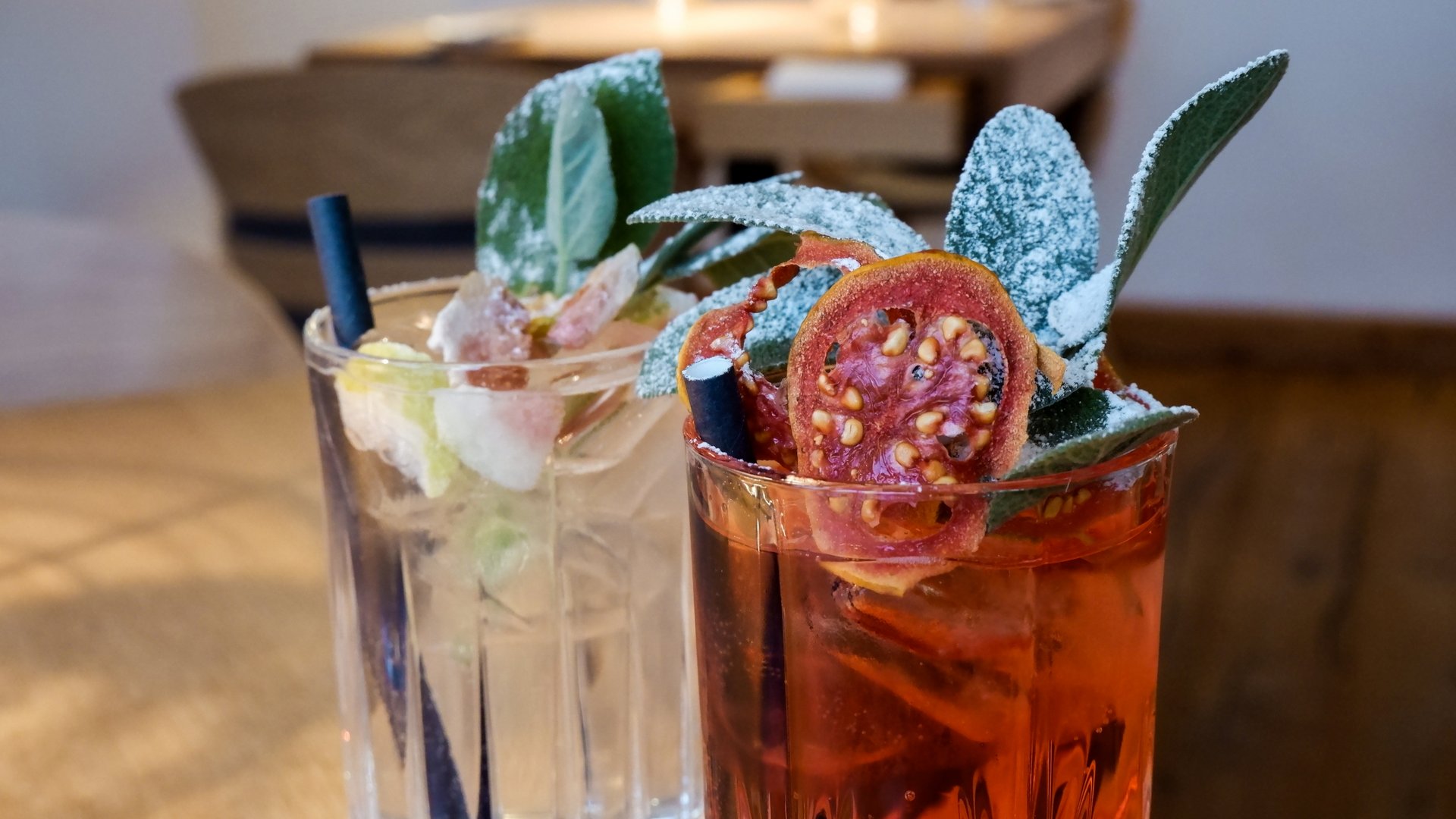 Romantik Hotel Hirschen: cuisine Two cocktails with ice and decorative herbs in glasses on wooden table
