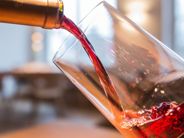 Romantik Hotel Hirschen: picture gallery Red wine being poured from a bottle into a glass