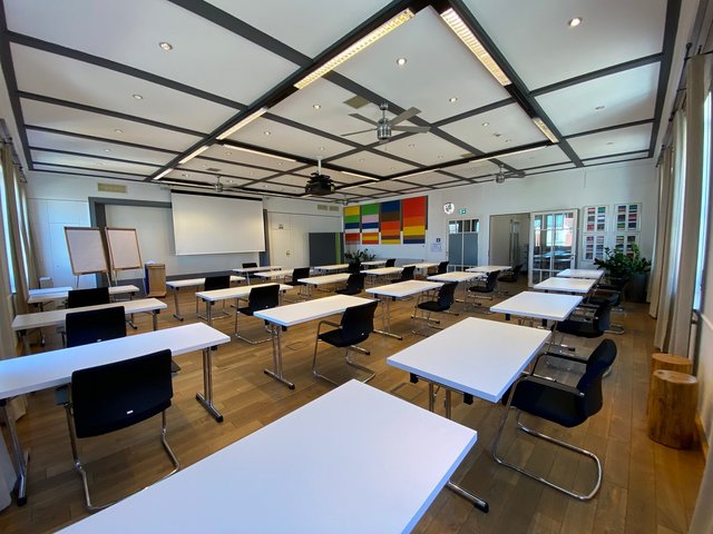 Romantik Hotel Hirschen: picture gallery Empty modern seminar room with white tables and black chairs