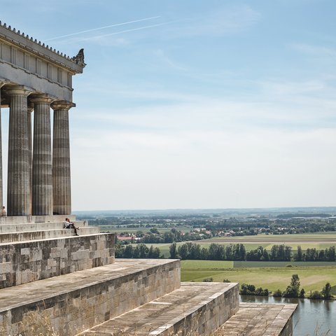 Culture & Attractions Around Regensburg Historic building with columns and steps overlooking river and landscape
