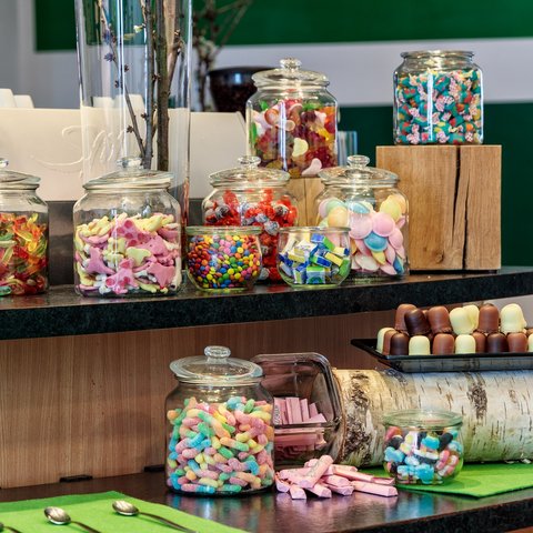 Looking for somewhere for conferences in Bavaria? Several jars filled with colorful candies on a counter
