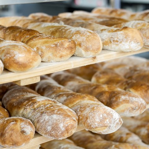 Gasthof Parsberg: Ein Gruß an den guten Geschmack Frisch gebackene Baguettes auf Holzregalen in einer Bäckerei