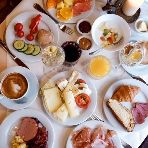 Gasthof Parsberg: Ein Gruß an den guten Geschmack Verschiedene Frühstücksteller mit Obst, Käse, Aufschnitt, Gebäck und Getränken auf einem Tisch