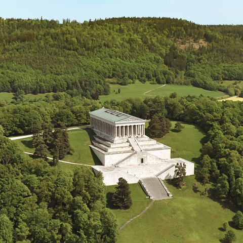 Culture & Attractions Around Regensburg Aerial view of a historic temple surrounded by dense forest and green meadows