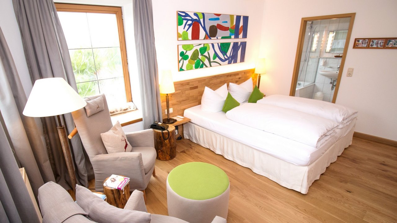 Romantik Hotel Hirschen: cuisine Cozy hotel room with double bed, armchairs, and modern bathroom