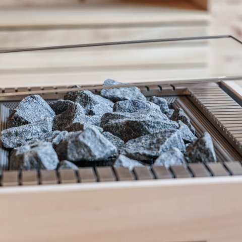 Day wellness in Upper Palatinate Sauna heater with hot sauna stones in a wooden sauna